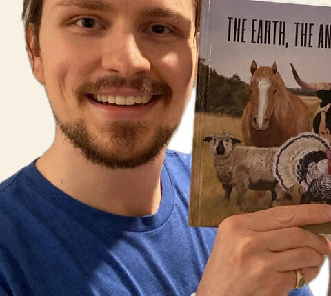 Porter Johnson holding The Earth, the Animals, and Me